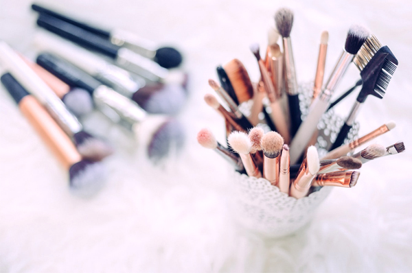 Wedding Makeup Artist - Various Brushes In A Cup And Lying On Table