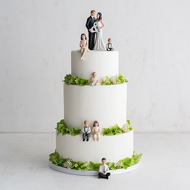 Family With Kids Wedding Cake Toppers On White Cake With Green Trim