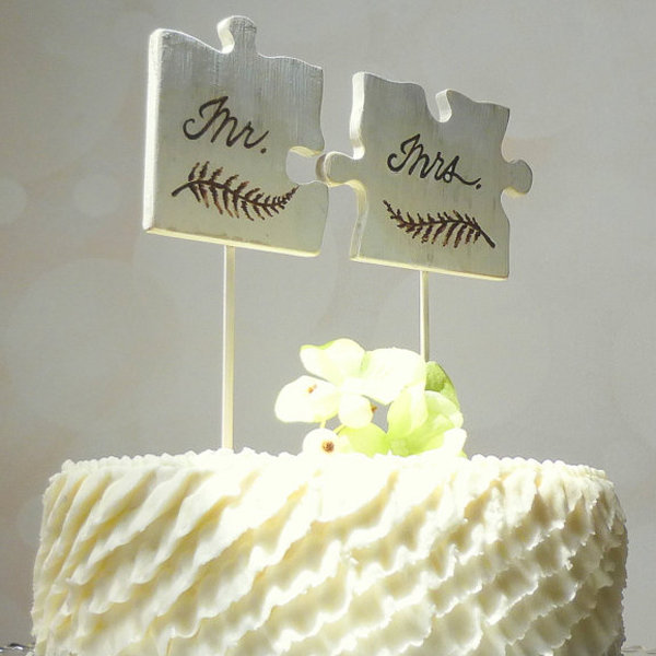 Puzzle Piece Wedding Cake Toppers On White Textured Cake