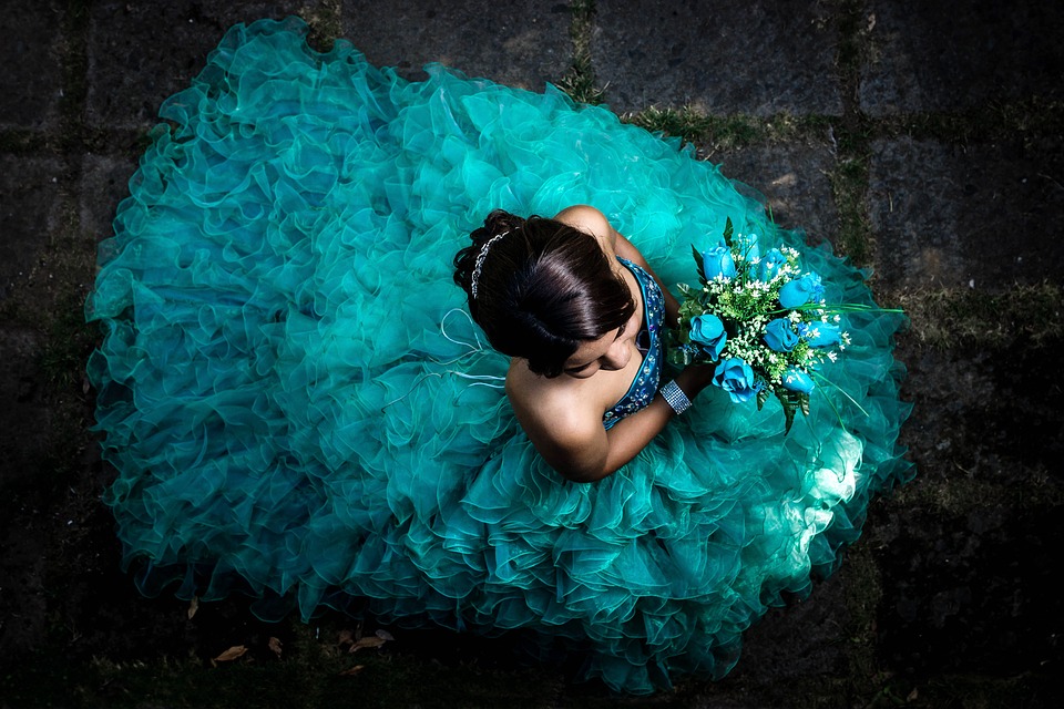 Quinceañera Planning Tips That Are Actually Helpful Birds Eye View Of A Teal Quinceanera Dress And Bouquet - Quinceanera Planning