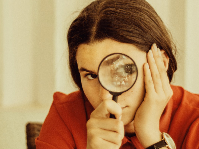 5 Commonly Made Wedding Invitation Mistakes To Avoid Brunette Woman With Magnifying Glass