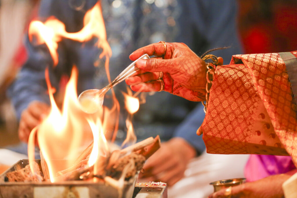Indian Wedding Venues And Traditions Putting Spoon In Fire During Indian Wedding Tradition.